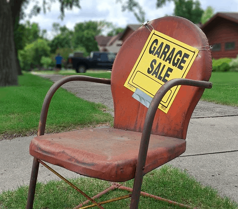 A chair in front of a garage sale.