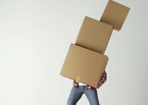 Moving boxes by himself.