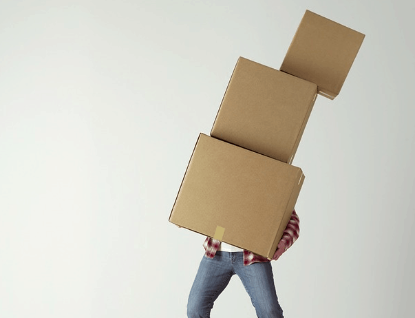 Moving boxes by himself.