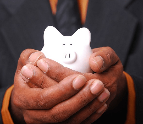 A iggy bank in hand from an emergency savings.