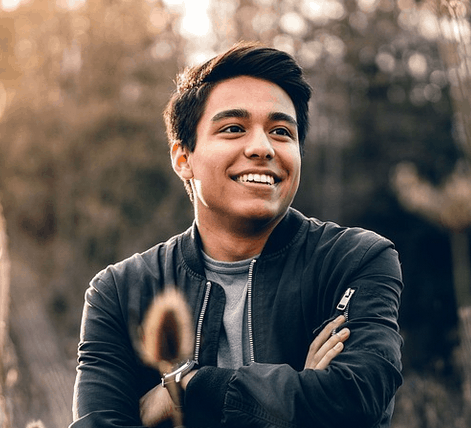 A person who needs $2200 standing in a field.