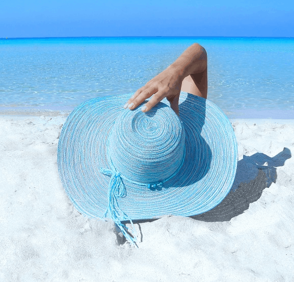 A woman on a beach who saved money for a trip.