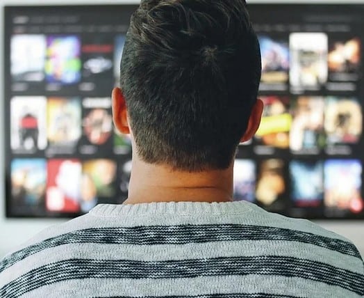 A person watching their new television.