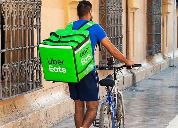 A person delivering food for extra money.