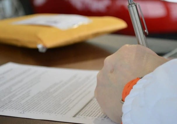 A person signing for a loan.