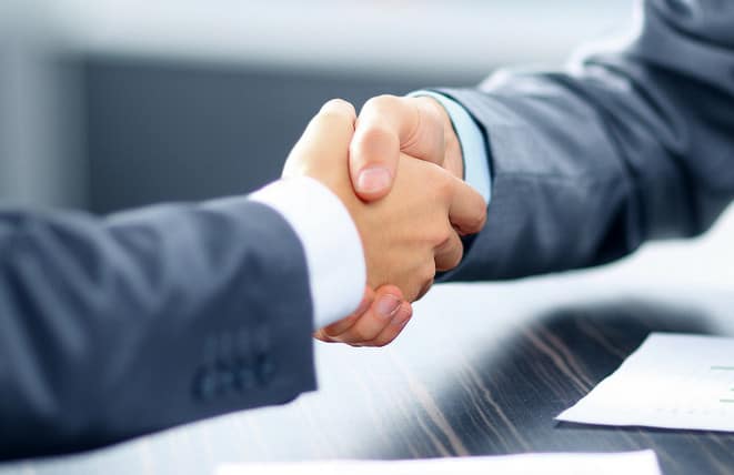 Shaking hands at a loan signing.