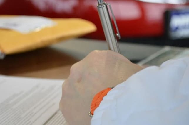 Signing a vehicle contract.