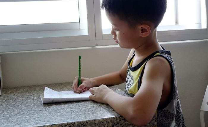 A child writing a budget.