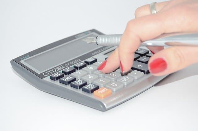 A calculator being used to slash household expenses.