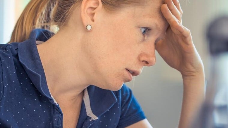 A woman stressed about debt.